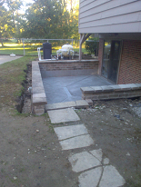 New concrete patio w/ trench drain installation & rebuilt retaining walls