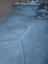 New concrete patio w/ trench drain installation & rebuilt retaining walls