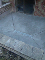 New concrete patio w/ trench drain installation & rebuilt retaining walls