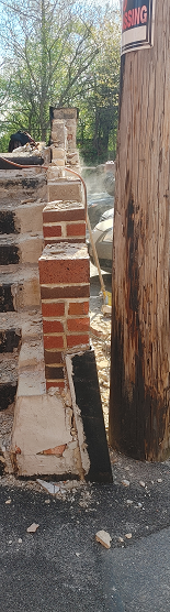 Rebuilt wing wall section in response to water breaching into underground garage