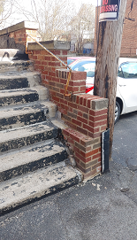 Rebuilt wing wall section in response to water breaching into underground garage